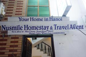 a sign that reads your home in hanoinsic homnsics and travel agent at Nusmile's Homestay & Travel in Hanoi