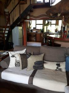 ein Sofa mit Kissen darauf im Wohnzimmer in der Unterkunft Canyon guest villa in Hoedspruit