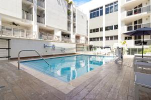 a swimming pool in front of a building at Roami at Habitat Brickell in Miami