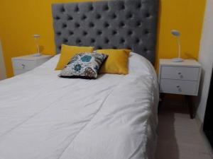 1 cama grande con cabecero gris y 2 mesitas de noche en San Isidro-Lince- Next to Business District!, en Lima