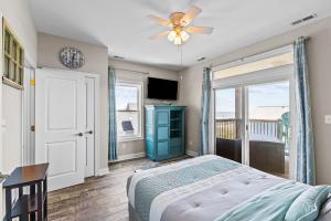 a bedroom with a bed and a ceiling fan at Ocean Crystal A in Atlantic Beach