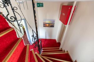 a staircase with red carpeting and a red stair case at OttomanZade in Istanbul