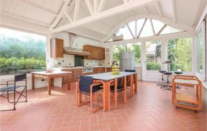 a kitchen with a table and some chairs in it at Green House in Comiso