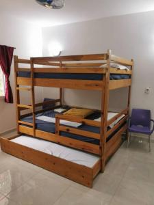 two bunk beds in a room with a blue chair at CasaCanda king size in Somone