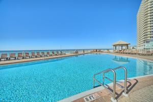 a large swimming pool with the beach in the background at Treasure Island 2103 in Panama City Beach