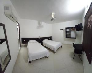Postel nebo postele na pokoji v ubytování HOTEL SAN ADOLFO