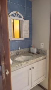 a bathroom with a sink and a mirror at Villa Andorinha -Apto01 in Mucugê +30 photos