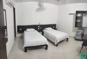 Postel nebo postele na pokoji v ubytování HOTEL SAN ADOLFO