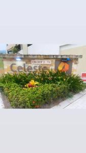 a sign on a building with plants and flowers at Greece In Home in Girardot