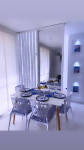 a dining room with a table and chairs and a mirror at Greece In Home in Girardot