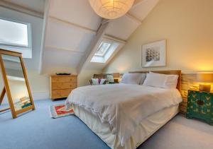a bedroom with a large bed in a attic at The Corn Mill in Solva