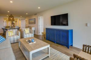 a living room with a blue cabinet and a tv at Port Aransas Vacation Rental with Pools - Near Beach in Port Aransas