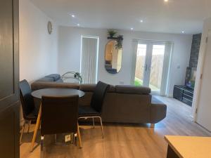 a living room with a couch and a table at Eaglet luxury home in Manchester
