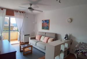 a living room with a couch and a table at Apartamento con piscina en Portosín in Portosin