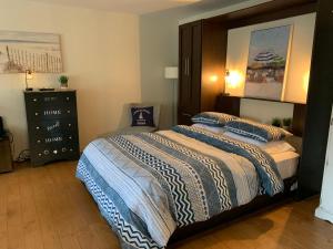 a bedroom with a large bed and a dresser at L'Authentique in Orford +22 photos