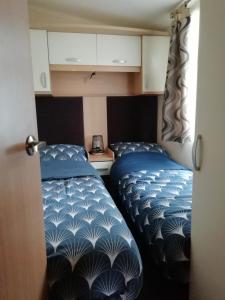 two beds sitting next to each other in a room at Chalet op de Holterberg in Holten