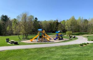 a park with two slides and a playground at L'Authentique in Orford