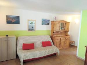 Cette chambre comprend un lit avec 2 oreillers rouges. dans l'établissement GRANDE VILLA TIZZANO A 200 M DE LA PLAGE 18 PERS, à Sartène