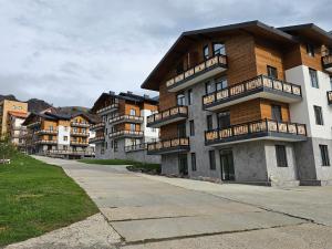a building with balconies on the side of a street at Bakuriani Ski Apartment-Didveli Tulip A34 in Bakuriani
