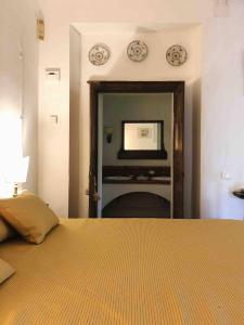 a bedroom with a bed and a tv on the wall at Il Giardorto in Casalini +22 photos