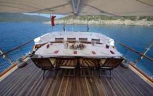 a table on the deck of a boat in the water at Arielle 1 - Lüks Tekne in Fethiye