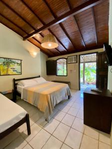 a bedroom with a large bed in a room at Pousada Tubarão in Arraial d'Ajuda +114 photos