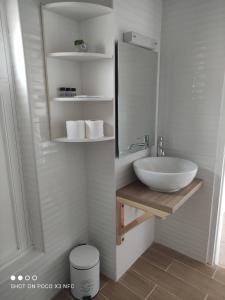 a bathroom with a sink and a mirror at Vetti Rooms in Skiathos