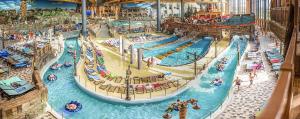 a large indoor water park with many people in it at Au coeur de l'Alsace in Eschau