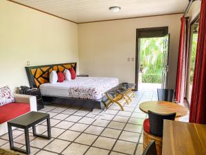 Ένα ή περισσότερα κρεβάτια σε δωμάτιο στο Arenal Manoa Resort & Hot Springs