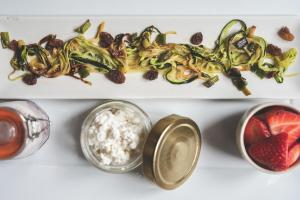 a plate of food with vegetables and fruit on a table at Tetxe B&B Roncal in Roncal