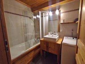 a bathroom with a sink and a shower and a toilet at L’Aster in Lanslebourg-Mont-Cenis