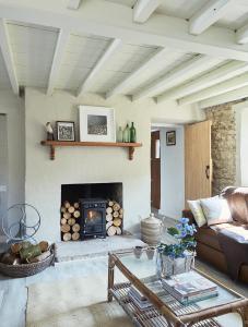 a living room with a couch and a fireplace at Kilquiggan Cottages in Coolkenna Street