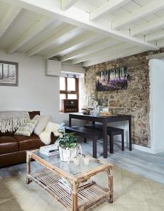 a living room with a couch and a table at Kilquiggan Cottages in Coolkenna Street