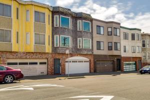 an apartment building with two garages in a parking lot at San Francisco Getaway Near Golden Gate Park in San Francisco