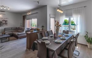 a dining room and living room with a table and chairs at 3 Bedroom Awesome Home In Marcana in Marčana