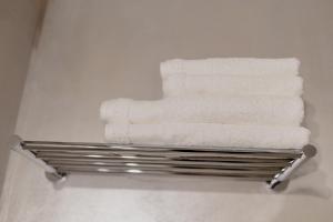 a towel rack with towels on it in a bathroom at No. 55 in Buzau +77 photos