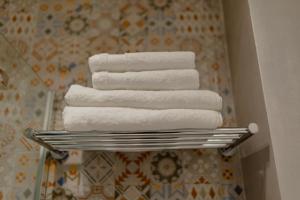 a stack of towels on a towel rack in a bathroom at No. 55 in Buzău +55 photos