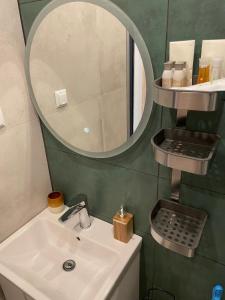 a bathroom with a sink and a mirror at Dream_Apartment in Varna City