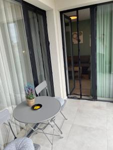a white table and chairs on a balcony with a table at Dream_Apartment in Varna City