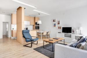 a living room with a couch and a table at Modern 2 Bedroom Apartment in Estrela with Outside Terrace! Amazing for Families, Couples, Friends in Lisbon