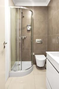 a bathroom with a shower and a toilet and a sink at Modern 2 Bedroom Apartment in Estrela with Outside Terrace! Amazing for Families, Couples, Friends in Lisbon