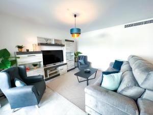 a living room with a couch and a tv at Apartment in Marbella Center with private parking in Marbella