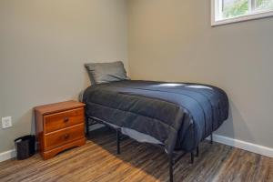 a small bedroom with a bed and a night stand at Zanesville Vacation Rental Near Downtown in Zanesville