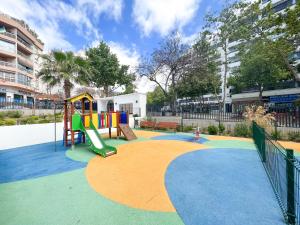 un parque infantil con tobogán en Apartment in Marbella Center with private parking en Marbella