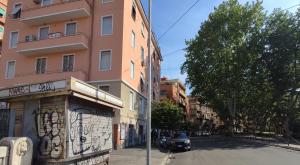 a building with graffiti on the side of a street at a pochi passi da Trastevere in Rome