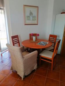 a dining room table and chairs with a table and chairsktop at Apartment Franka in Sveti Vid-Miholjice