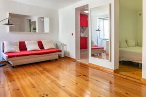 a living room with a couch and a bedroom at Studio in the heart of Alfama! Super Central! in Lisbon