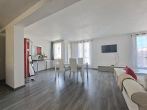 a living room with a table and chairs at BONCOIN in Royan