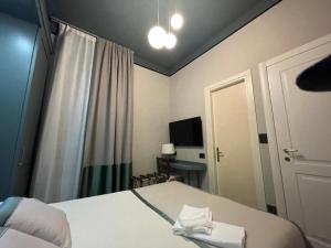a hotel room with a bed and a television at Villa Margherita in Levanto