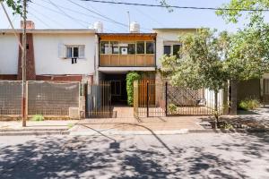 a house with a gate in front of it at CORAGGIOSA in Mendoza